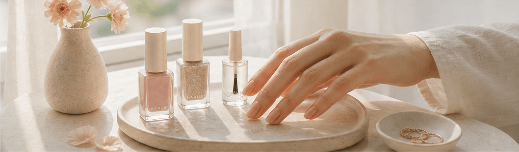 Rose, nude, and plum nail samples arranged on ivory washi paper